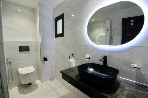 a bathroom with a black sink and a mirror at La Colongette in Antsirabe