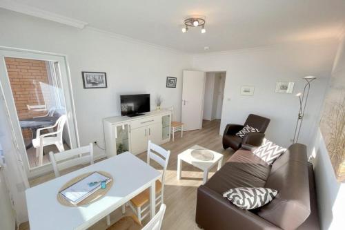 a living room with a couch and a table at Appartement-162 in Westerland