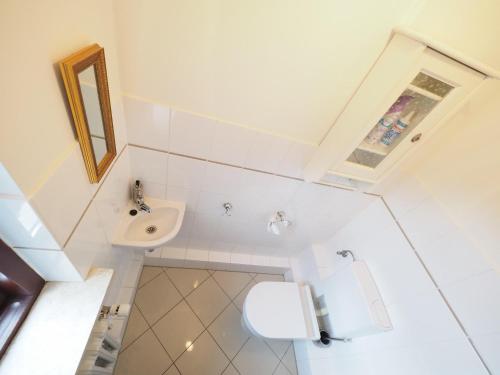 a small bathroom with a sink and a toilet at Haus-Bockelmann in Westerland