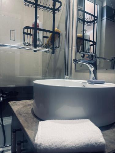a bathroom with a white sink and a mirror at Nàra house in Áyios Spirídhon