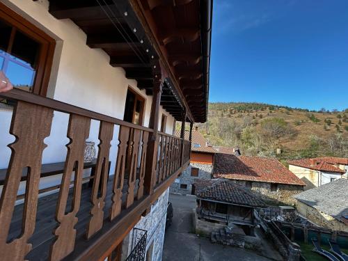 a balcony of a building with a view of a town at La Balconada de Valdeón in Posada de Valdeón