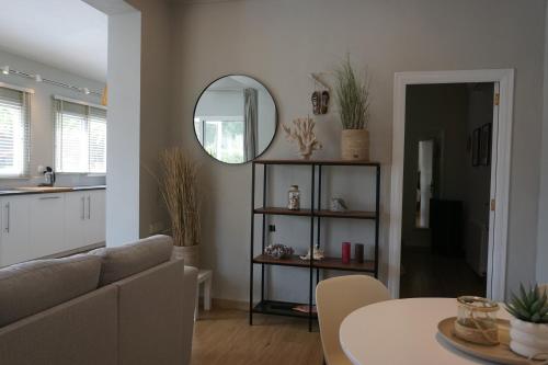 a living room with a table and a mirror at Atidos vakantie appartementen in Ontinyent