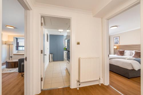 a bedroom with a bed and a living room at Monarch House - Serviced Apartments - Kensington in London