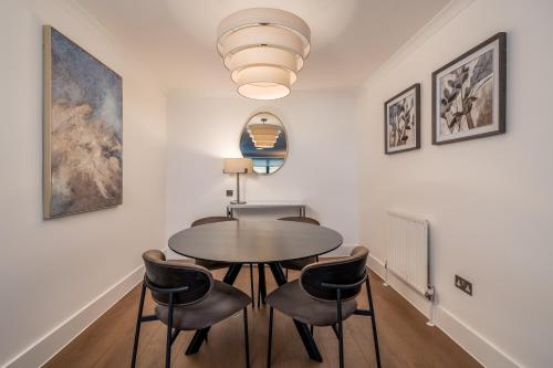 a dining room with a table and chairs at Monarch House - Serviced Apartments - Kensington in London