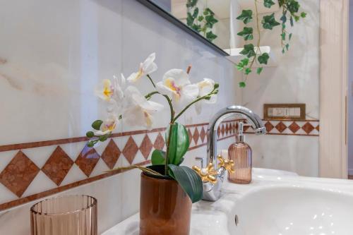 a bathroom with a sink with a potted plant on it at Villa Alberta With Reserved Beach Spot in Marina di Massa