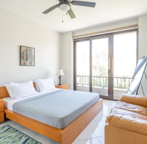 a bedroom with a bed and a couch at Marassi Stand alone luxury villa in El Alamein