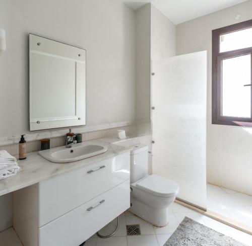a white bathroom with a sink and a toilet at Marassi Stand alone luxury villa in El Alamein