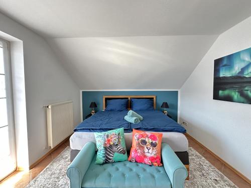 a bedroom with a blue bed and a couch at Charly`s Place in Rain