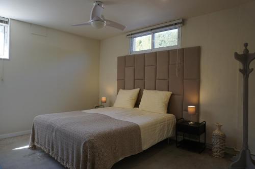 a bedroom with a large bed and two windows at Atidos vakantie appartementen in Ontinyent