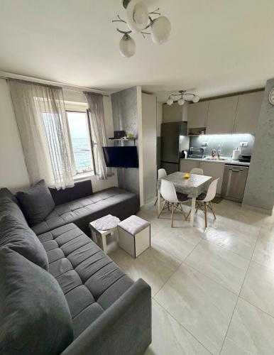 a living room with a couch and a table at Lili's Sea View in Budva
