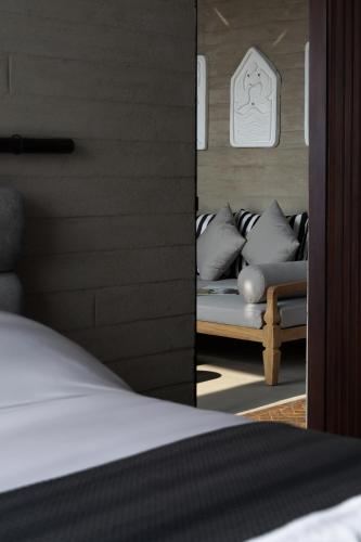 a bedroom with a couch in a room at Orama Bali in Uluwatu