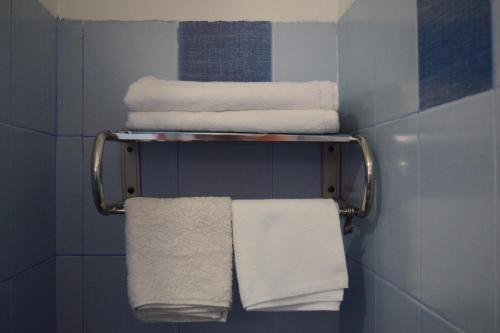 a bunch of towels on a rack in a bathroom at Hạnh Homestay in Thôn Trị Thủy