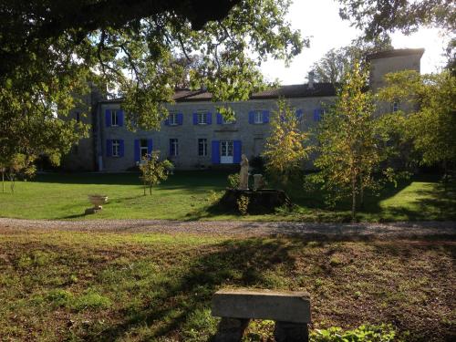a large blue house with a bench in front of it at Château de Verdalle in Verdalle