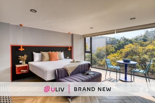 a bedroom with a bed and a balcony at ULIV Condesa in Mexico City
