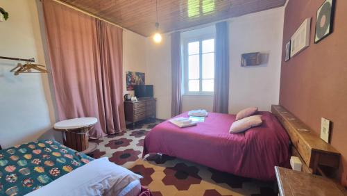 a bedroom with a pink bed and a window at Villa Sunrise in Lucca