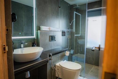 a bathroom with a toilet and a sink and a shower at 31 Park Hotel in Pokhara