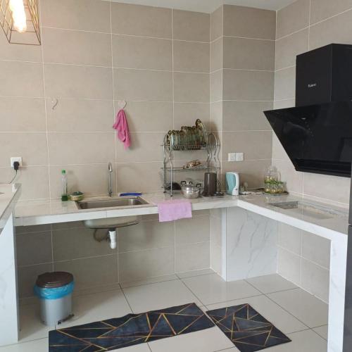 a kitchen with a sink and a counter top at Sunway Onsen Apartment Tambun by ELK Homestay in Tambun