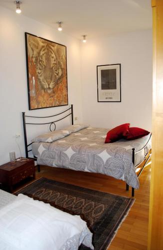 two beds in a room with a painting on the wall at La Collina D'Oro in Cernobbio