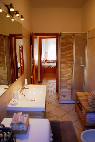a bathroom with a sink and a shower and a mirror at La Collina D'Oro in Cernobbio