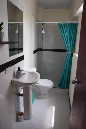 a bathroom with a sink and a toilet and a shower at Casa Esperanza in Cali