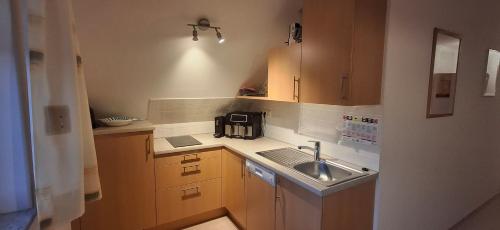 a small kitchen with a sink and a microwave at Ferienhaus Zotter in Feldbach