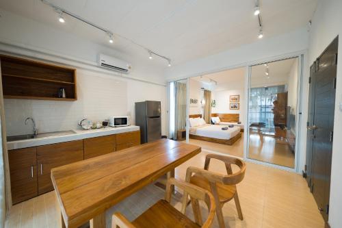 a kitchen with a wooden table and chairs in a room at Chiang Mai Mansion 2 in Chiang Mai