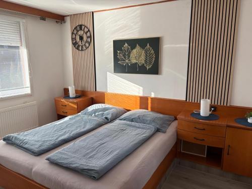 a bedroom with two twin beds and a desk at Chata Na Pasekách in Rajnochovice