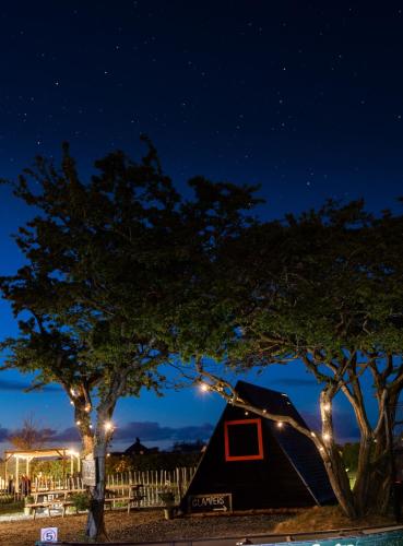 a black tent under a night sky with trees at Carrowmena School House & Glamping in Limavady