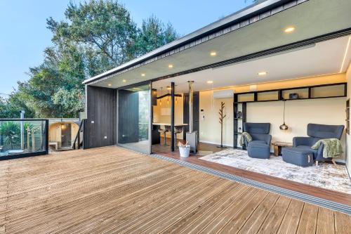 a house with a large deck with glass doors at Zaire Lodge in Mira
