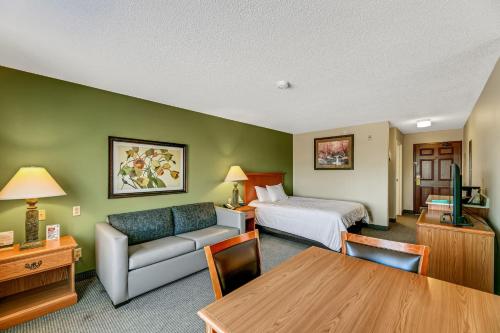 a hotel room with a bed and a couch at Country Inn Walker in Walker