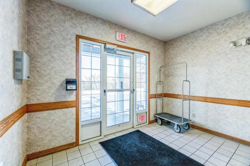 a room with a shower with a cart in it at Country Inn Walker in Walker