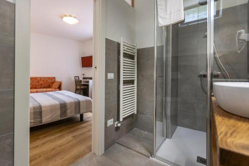 a bathroom with a shower and a sink at Hotel Al Molino in Malcesine