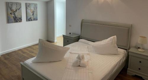 a bedroom with a bed with a teddy bear on it at Dare apartments 2 in Giurgiu