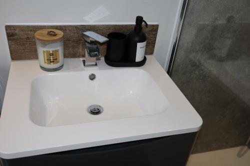 a white sink with a bottle of wine on it at Lush Rooms Bedminster in Bristol
