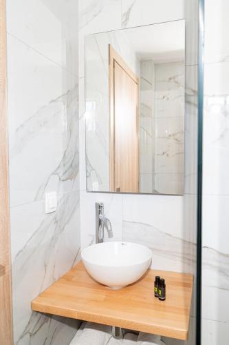 a bathroom with a white sink and a mirror at Theoni Garden in Parga
