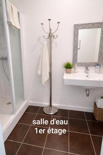 a bathroom with a sink and a mirror at Maison Suzanne, Downtown, 6 Guests in Cancale