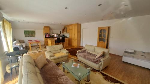 a living room with a couch and a table at Podlugovi House Villa in Podlugovi