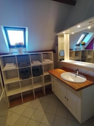 a bathroom with a sink and a mirror at L'épi de blé in Saint-Astier