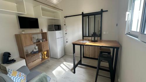 a small kitchen with a table in a small room at Chambre spacieuse et moderne in Sallertaine