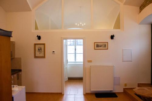 a living room with a door and a window at Zámek Dobrohoř in Dobrohoř