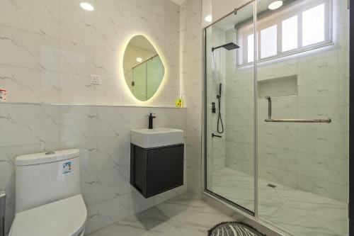 a bathroom with a shower and a toilet and a sink at Mex 1 bedrooms Lekki phase1 in Lagos