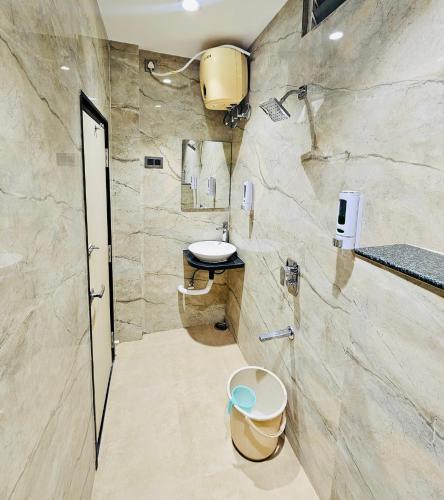 a bathroom with a sink and a toilet at Shankar Bhavan By Vinayak Hotels in Brahmapur
