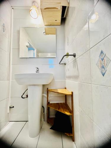 a bathroom with a sink and a mirror at Hotel Le Ponteil in Antibes