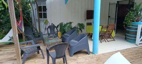 a group of chairs and tables on a patio at Chico's loc in Sainte-Luce