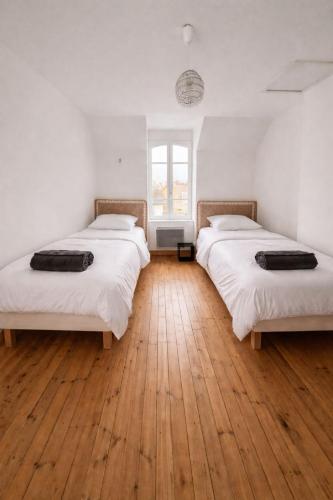 three beds in a room with a wooden floor at Maison Suzanne, Downtown, 6 Guests in Cancale
