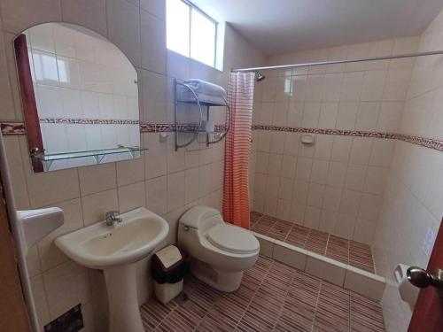 a bathroom with a toilet and a sink at Colca Terra in Chivay