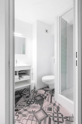 a bathroom with a toilet and a sink at The Originals Access, Hôtel Clermont-Ferrand Nord in Châteaugay