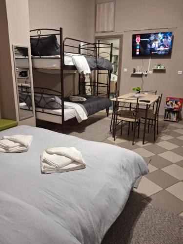 a room with two bunk beds and a table and a dining room at PREVEZA DOWNTOWN garden in Preveza
