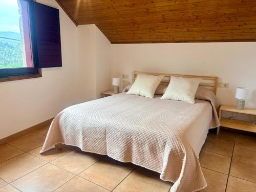 a bedroom with a bed with a wooden ceiling at LS Alojamiento Turístico in Arcade