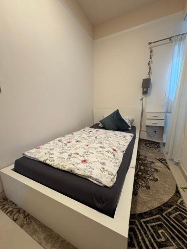 a bed in a white room with at Landglück in Ibbenbüren